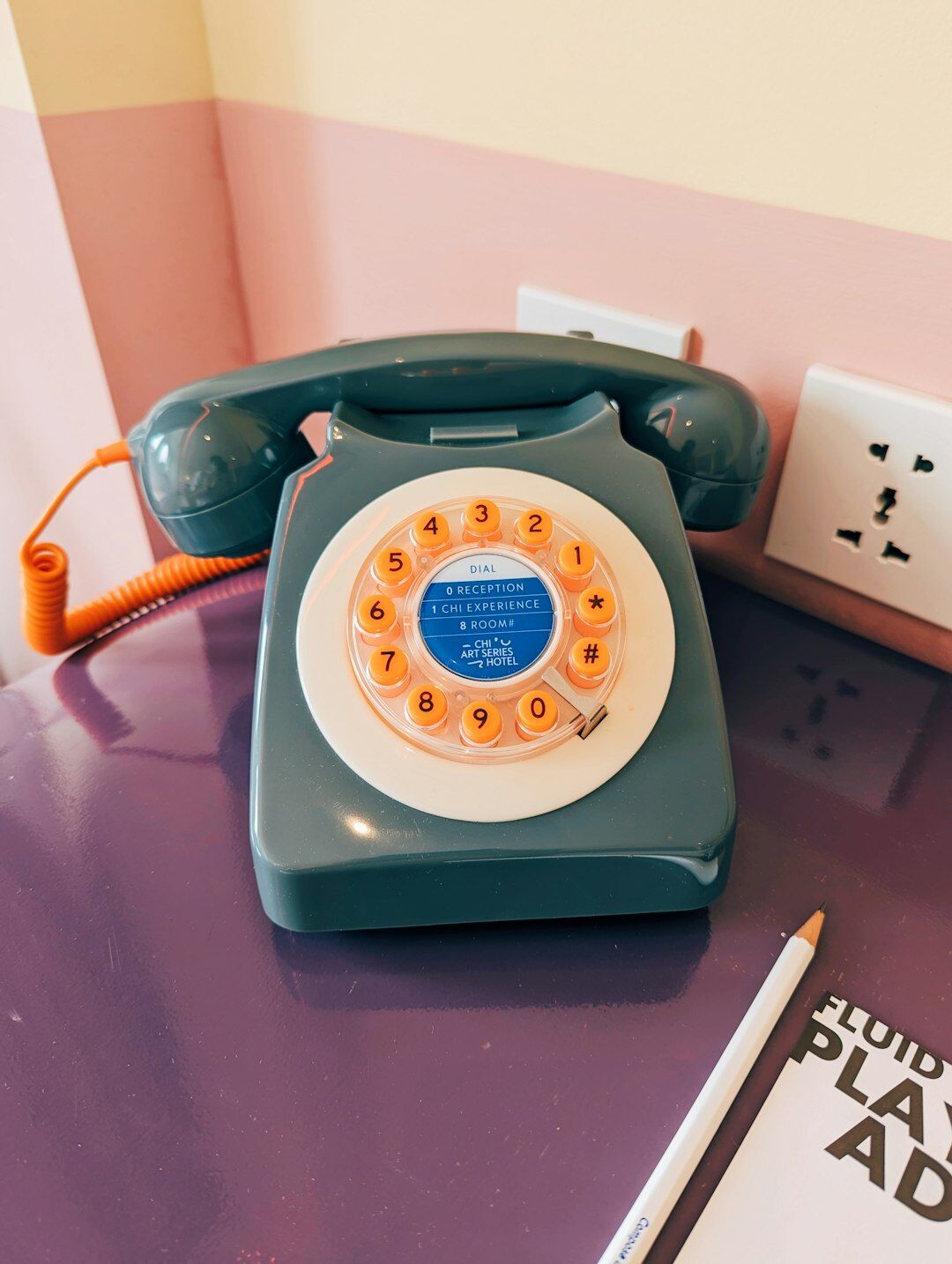 Quiet desk with a notebook, pen and rotary telephone used to receive tips